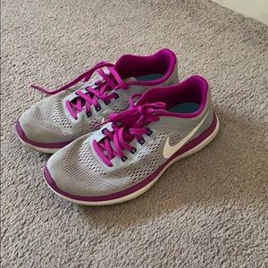 Grey  and purple Nike women’s sneakers.
